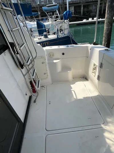  Yacht Photos Pics 1996 Bayliner 3788 Command Bridge Motoryacht deck with ladder and storage compartments.