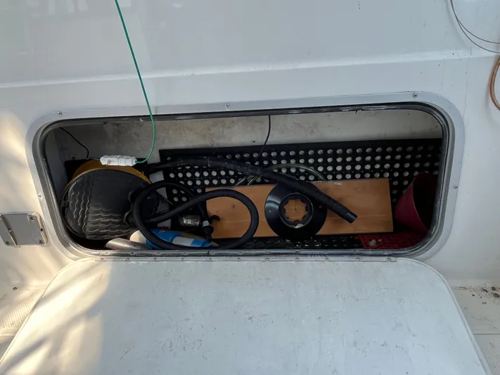  Yacht Photos Pics Storage compartment on a 1996 Bayliner 3788 Command Bridge Motoryacht with various boating equipment.