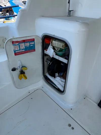  Yacht Photos Pics Open storage compartment on 1996 Bayliner 3788 Command Bridge Motoryacht, containing various boating supplies.