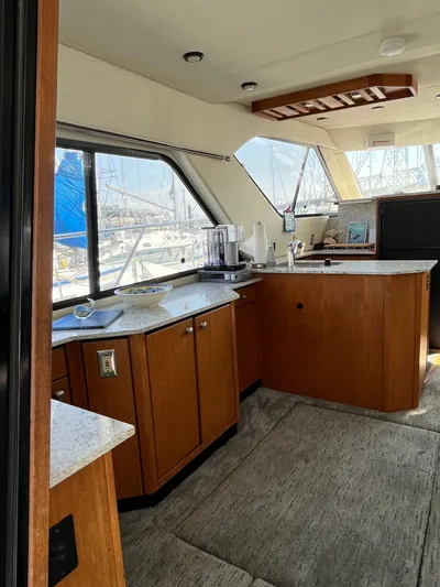  Yacht Photos Pics Interior of 1996 Bayliner 3788 Command Bridge Motoryacht with wooden cabinetry and large windows.