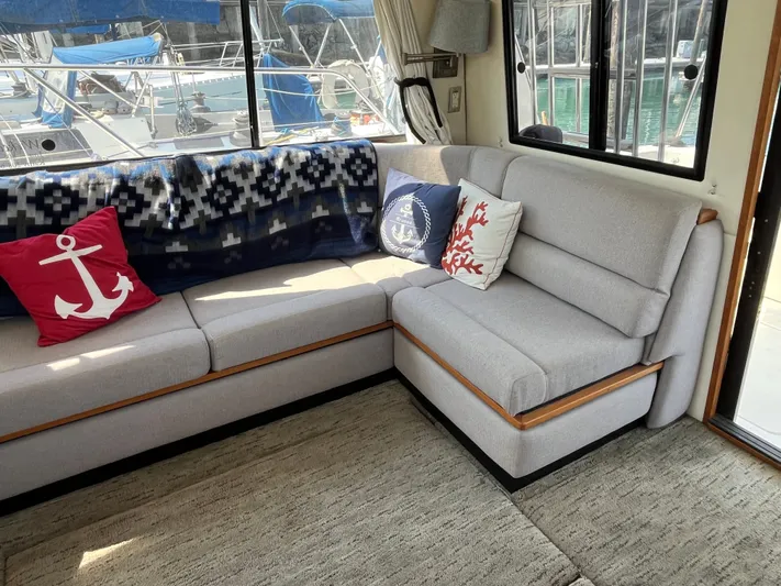  Yacht Photos Pics Interior of 1996 Bayliner 3788 Command Bridge Motoryacht with cozy seating and nautical-themed pillows.