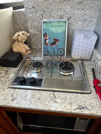  Yacht Photos Pics Compact kitchen area in a 1996 Bayliner 3788 yacht with a two-burner stove.