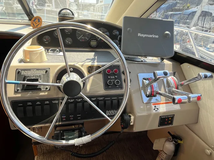  Yacht Photos Pics 1996 Bayliner 3788 Command Bridge Motoryacht helm with Raymarine navigation system and controls.