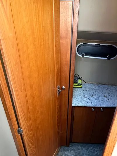  Yacht Photos Pics Interior of 1996 Bayliner 3788 Command Bridge Motoryacht with wooden cabinetry and small window.