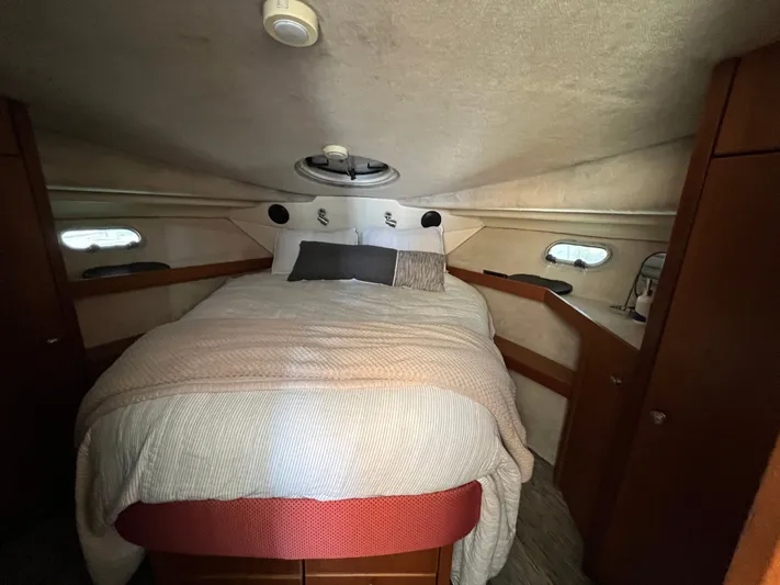  Yacht Photos Pics Cozy bedroom in 1996 Bayliner 3788 Command Bridge Motoryacht with plush bedding and porthole windows.