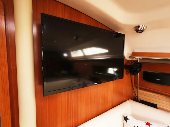  Yacht Photos Pics Flat-screen TV in 2021 Catalina C355 yacht interior, mounted on wooden paneling.