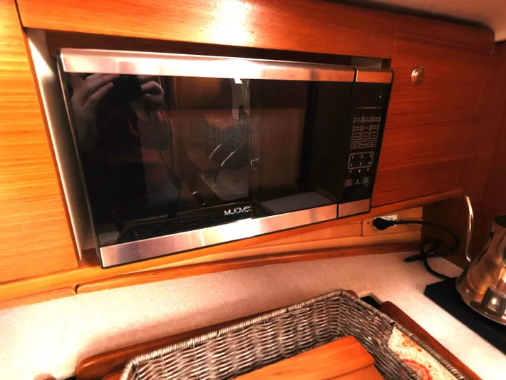  Yacht Photos Pics Microwave in 2021 Catalina C355 yacht kitchen with wooden cabinetry.