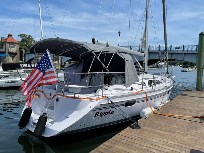  Yacht Photos Pics Catalina C355 sailboat docked, displaying American flag, with bridge in background.