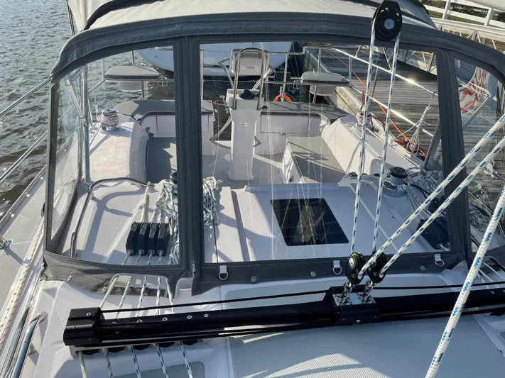  Yacht Photos Pics 2021 Catalina C355 sailboat cockpit with ropes and clear canopy, docked on calm water.