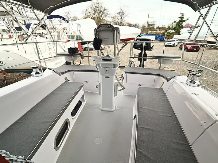  Yacht Photos Pics 2021 Catalina C355 sailboat cockpit with gray seating, steering wheel, and marina background.