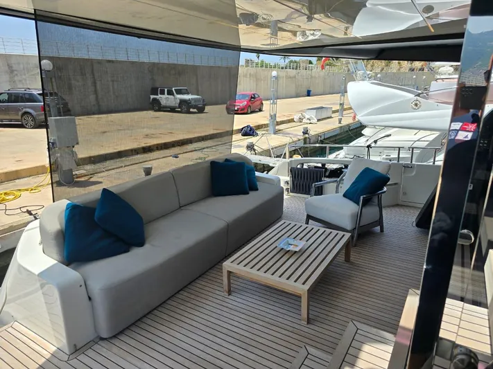  Yacht Photos Pics 2023 Cranchi Sessantasette 67 yacht deck with modern seating and table.