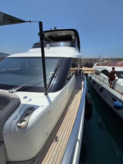  Yacht Photos Pics 2023 Cranchi Sessantasette 67 yacht docked in marina, side view.