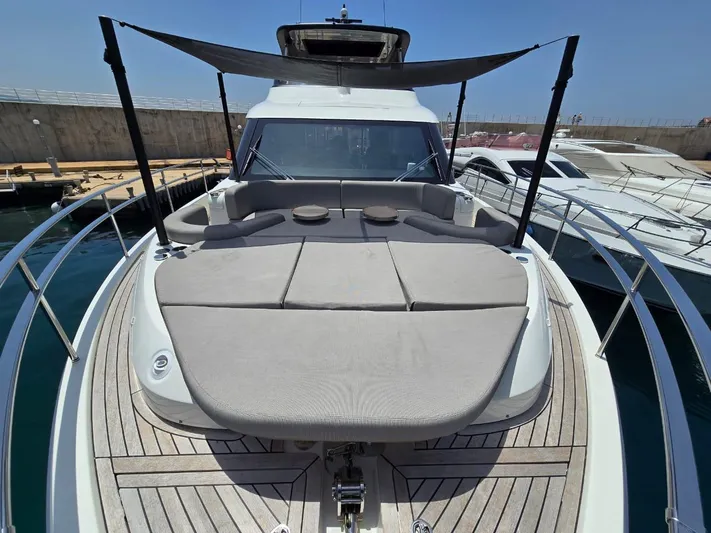  Yacht Photos Pics 2023 Cranchi Sessantasette 67 yacht with spacious deck and sunshade in marina.