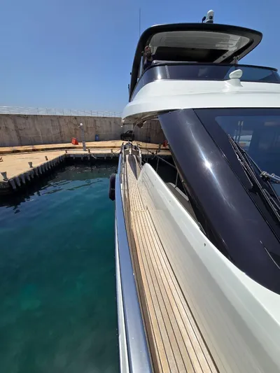  Yacht Photos Pics 2023 Cranchi Sessantasette 67 yacht docked at marina, side view.