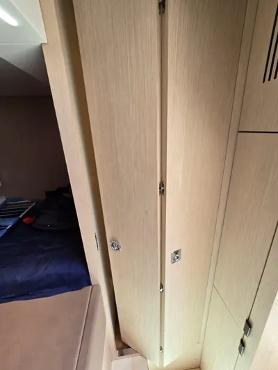  Yacht Photos Pics Interior of 2023 Cranchi Sessantasette 67 yacht, featuring wooden cabinetry and a cozy sleeping area.