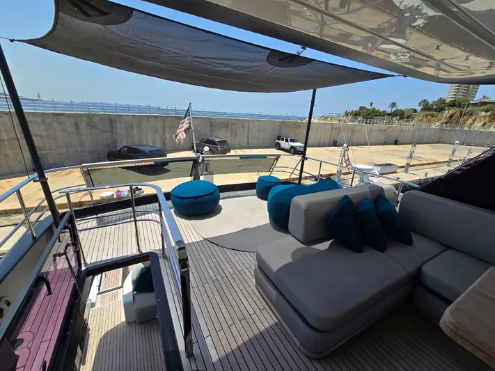  Yacht Photos Pics Luxurious 2023 Cranchi Sessantasette 67 yacht deck with comfortable seating and ocean view.
