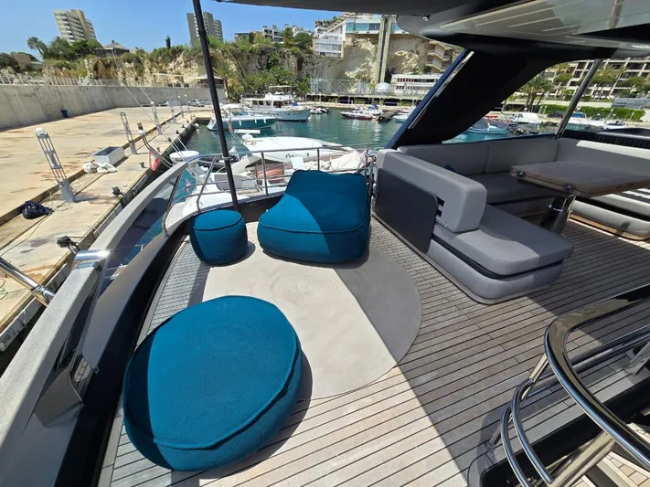  Yacht Photos Pics Luxurious 2023 Cranchi Sessantasette 67 yacht deck with modern seating and marina view.