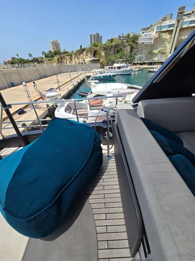  Yacht Photos Pics 2023 Cranchi Sessantasette 67 yacht docked at marina with modern seating.