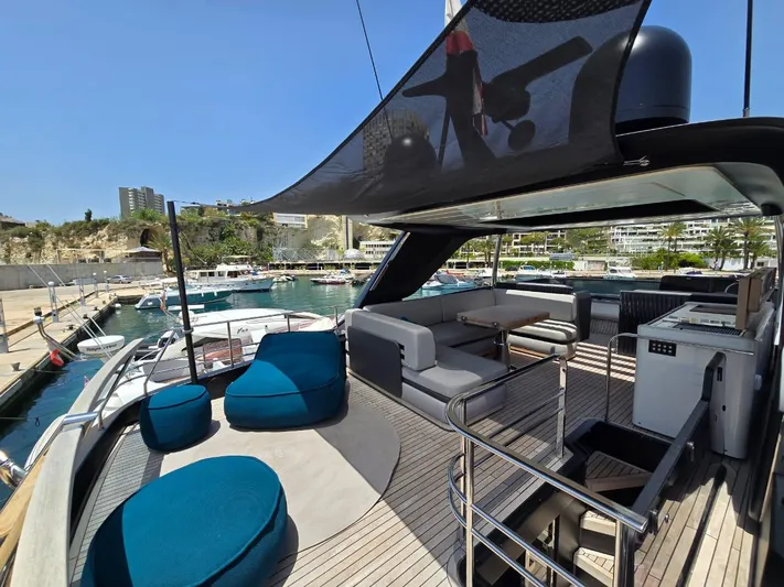  Yacht Photos Pics Luxurious 2023 Cranchi Sessantasette 67 yacht deck with modern seating and marina view.