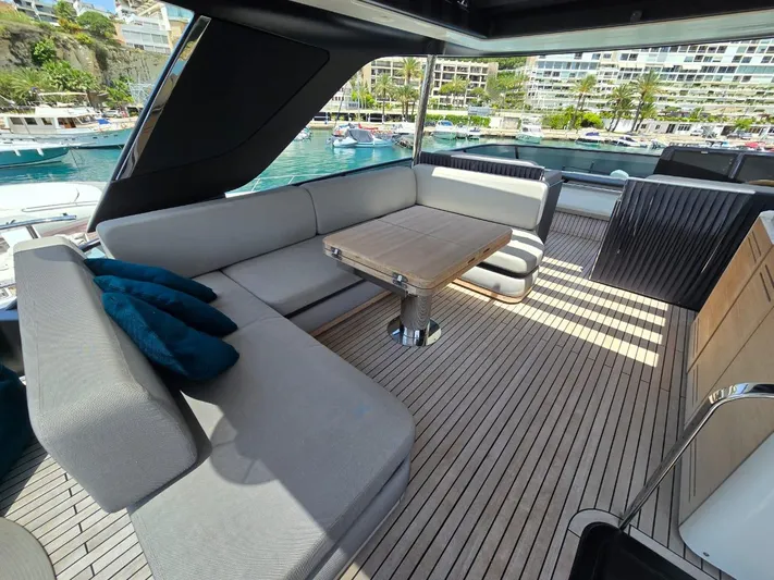 Yacht Photos Pics Luxurious 2023 Cranchi Sessantasette 67 yacht deck with elegant seating and table.