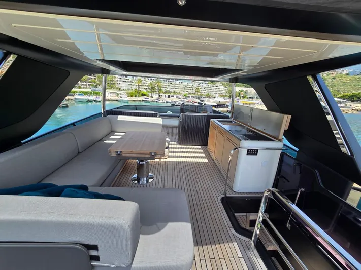  Yacht Photos Pics Luxurious interior of 2023 Cranchi Sessantasette 67 yacht with modern seating and kitchenette.