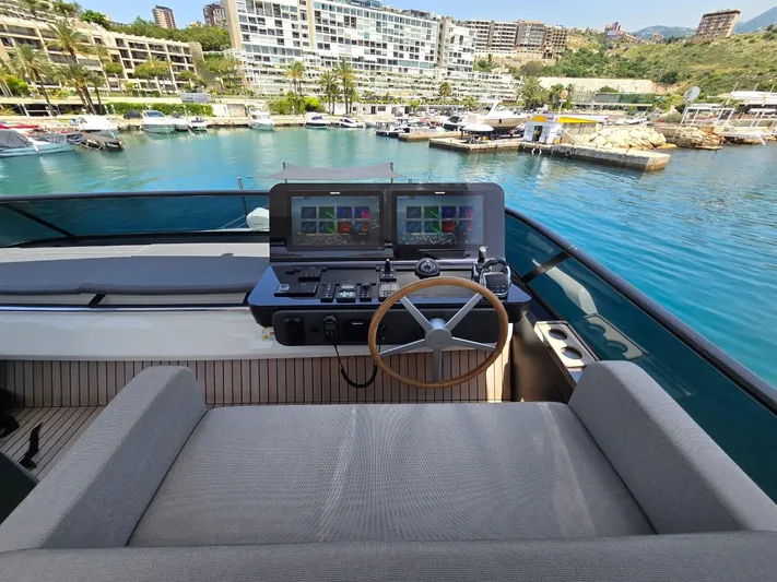  Yacht Photos Pics 2023 Cranchi Sessantasette 67 yacht helm with dual screens, overlooking marina.