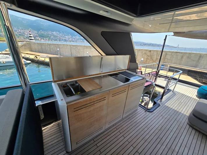  Yacht Photos Pics Outdoor kitchen on 2023 Cranchi Sessantasette 67 yacht with scenic marina view.