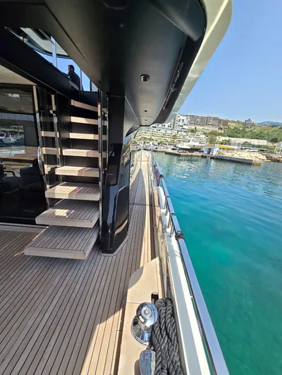  Yacht Photos Pics 2023 Cranchi Sessantasette 67 yacht, side deck view with stairs, docked in a marina.