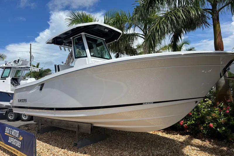  Yacht Photos Pics 2025 Blackfin 252 CC boat displayed outdoors with palm trees and blue sky.