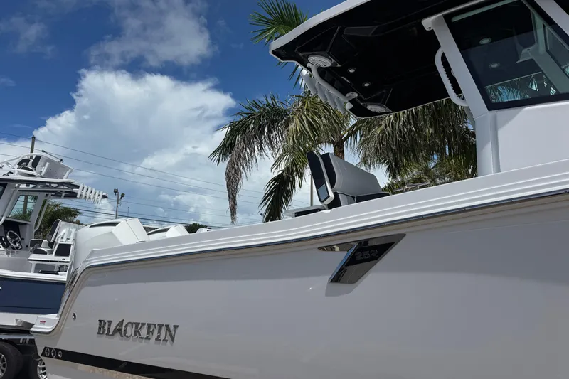  Yacht Photos Pics 2025 Blackfin 252 CC boat under clear blue sky with palm trees.