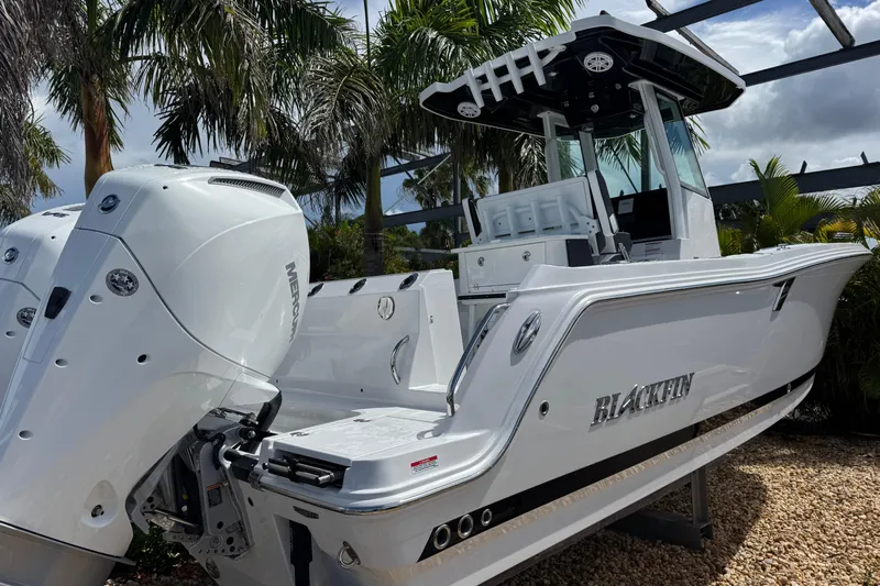  Yacht Photos Pics 2025 Blackfin 252 CC boat with dual Mercury engines, set against a tropical backdrop.