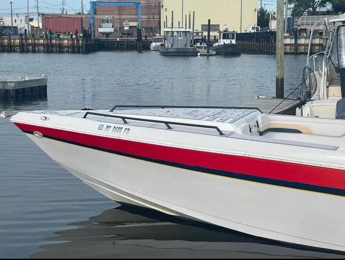  Yacht Photos Pics 2004 Donzi 35 ZF boat docked in a marina, featuring a sleek red and white design.