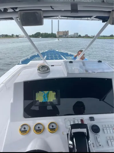  Yacht Photos Pics 2004 Donzi 35 ZF boat dashboard with navigation system on open water.