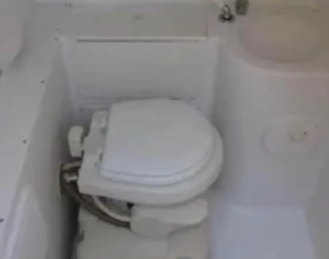  Yacht Photos Pics 2004 Donzi 35 ZF boat bathroom with compact toilet and sink.