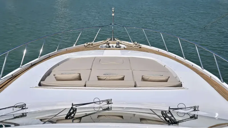  Yacht Photos Pics Luxurious 2009 Mangusta 92 yacht deck with sunbathing area on calm water.