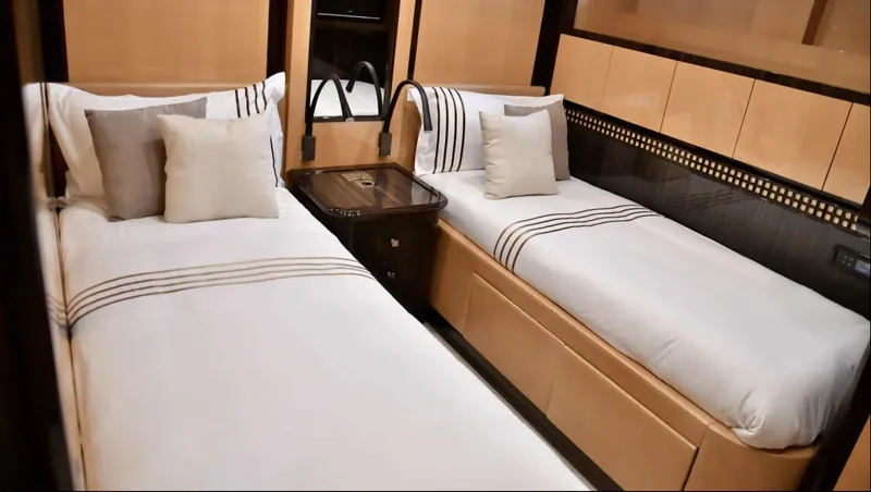  Yacht Photos Pics Luxurious twin bedroom on 2009 Mangusta 92 yacht with elegant decor and plush bedding.
