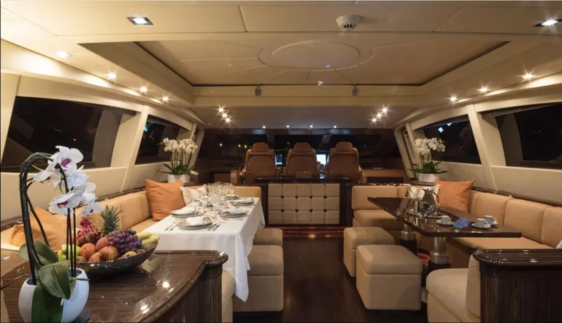  Yacht Photos Pics Luxurious interior of 2009 Mangusta 92 yacht with elegant dining and seating area.