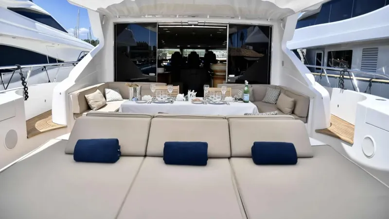  Yacht Photos Pics Luxurious 2009 Mangusta 92 yacht deck with elegant seating and dining area.