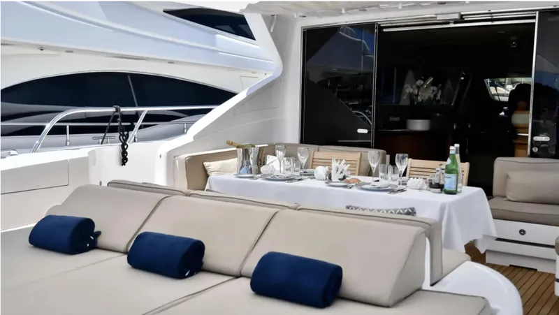  Yacht Photos Pics Luxurious 2009 Mangusta 92 yacht with elegant outdoor dining setup.