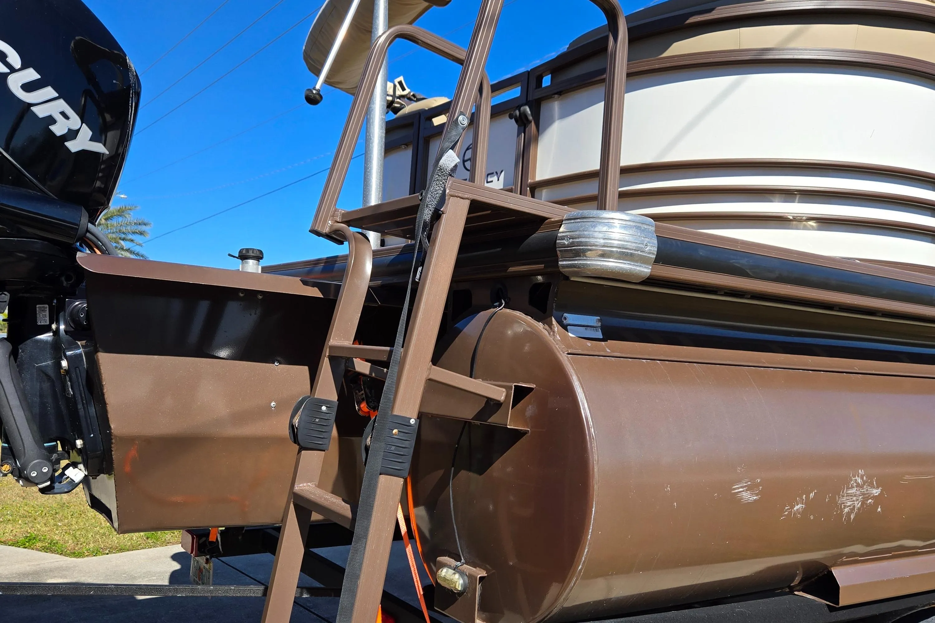 2017 Regency 254 LE3 pontoon boat with ladder and Mercury engine.