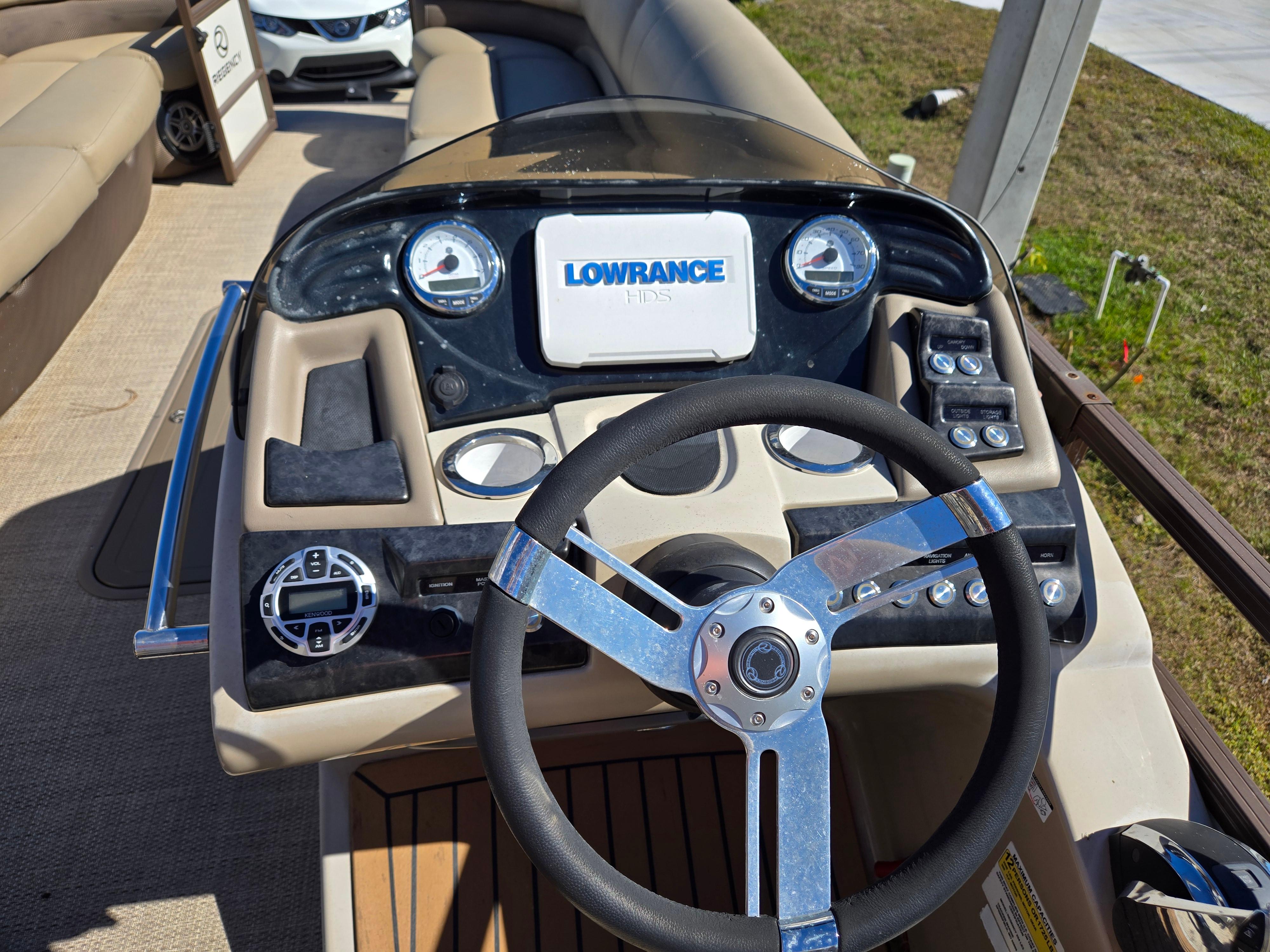 2017 Regency 254 LE3 boat dashboard with Lowrance display and steering wheel.