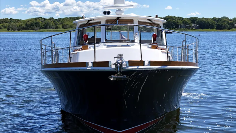 Ballena Yacht Photos Pics 2002 Grand Banks 49 Eastbay HX yacht on calm water, front view.