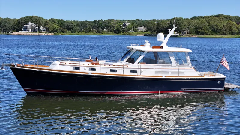 Ballena Yacht Photos Pics 2002 Grand Banks 49 Eastbay HX yacht on calm water with scenic background.