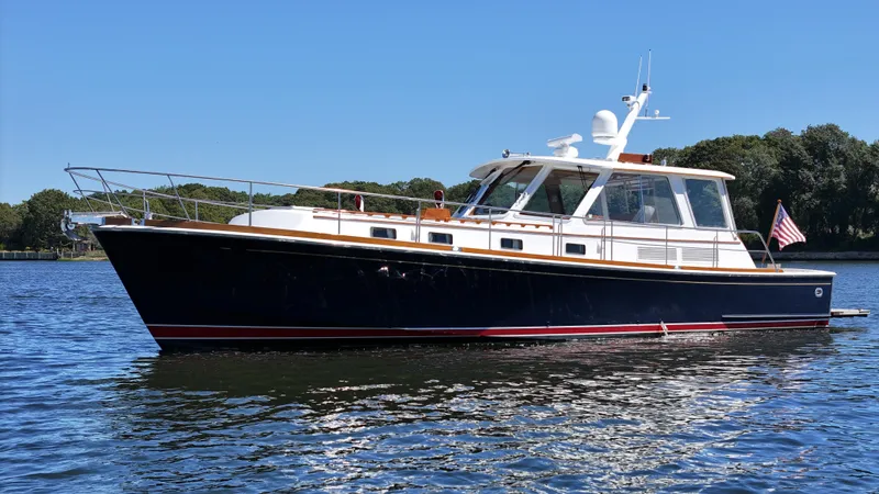 Ballena Yacht Photos Pics 2002 Grand Banks 49 Eastbay HX yacht on calm water, clear sky background.