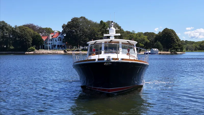 Ballena Yacht Photos Pics 2002 Grand Banks 49 Eastbay HX yacht cruising on a scenic lake.