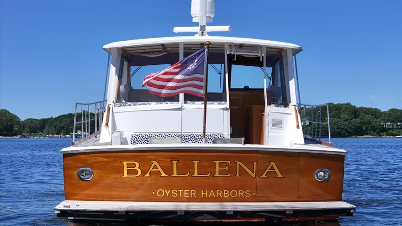 Ballena Yacht Photos Pics 2002 Grand Banks 49 Eastbay HX boat named Ballena on water, American flag waving.