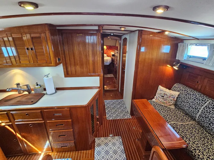 Ballena Yacht Photos Pics Luxurious 2002 Grand Banks 49 Eastbay HX yacht interior with elegant wood finishes and cozy seating.