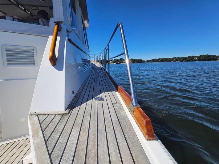 Ballena Yacht Photos Pics 2002 Grand Banks 49 Eastbay HX yacht deck with ocean view and clear blue sky.