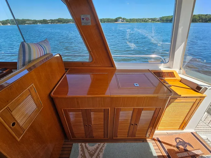 Ballena Yacht Photos Pics Interior of 2002 Grand Banks 49 Eastbay HX yacht with wooden cabinetry and scenic water view.