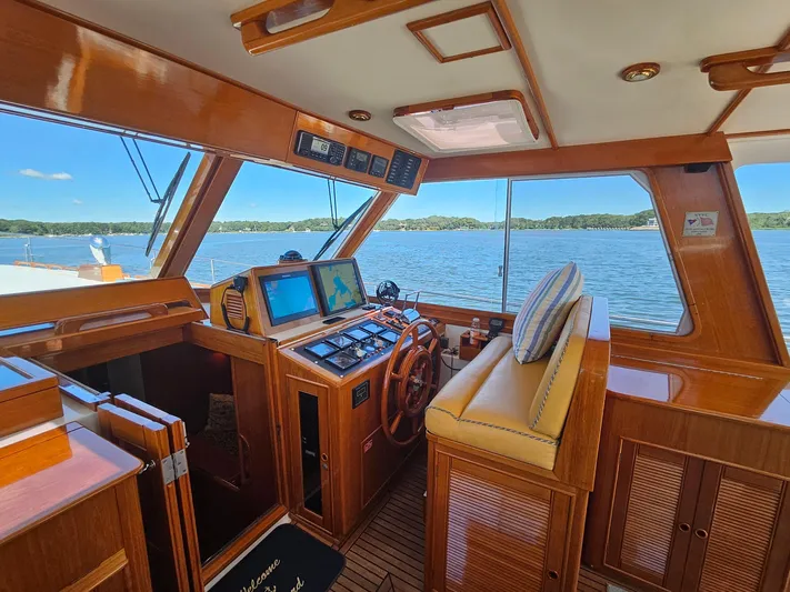 Ballena Yacht Photos Pics Interior of 2002 Grand Banks 49 Eastbay HX yacht with wooden helm and navigation screens.